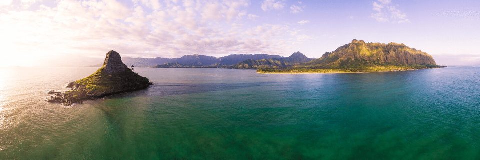 Aerial panorama of Mokoliʻi islet at sunrise with the Kualoa ridge and Kāneʻohe Bay behind it