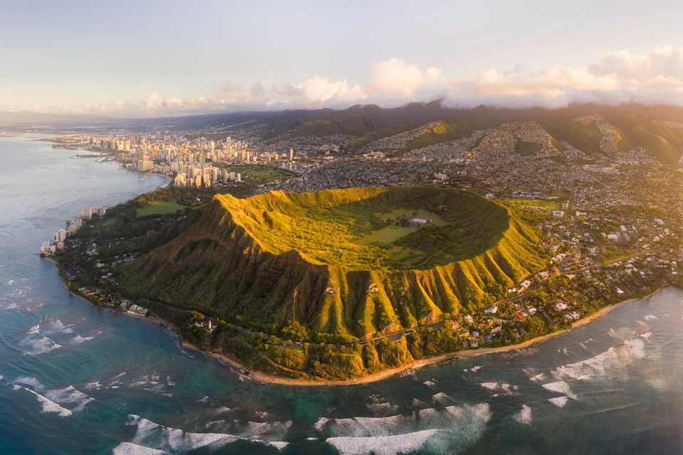 Aerial view of Diamond Head crater at sunrise with Waikīkī and Honolulu beyond
