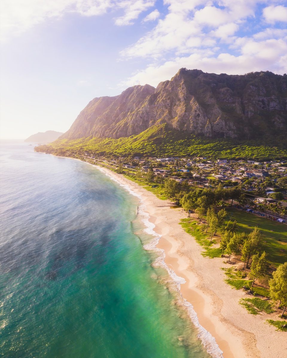 Aerial view down Waimānalo Beach toward the Koʻolau cliffs, scalloped patterns in the sand